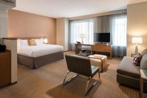a hotel room with a bed and a desk and a couch at Courtyard by Marriott Los Angeles L.A. LIVE in Los Angeles