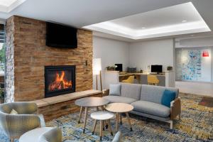 a living room with a couch and a fireplace at TownPlaces Suite Denver Airport at Gateway Park in Aurora