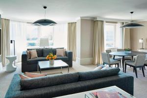 a living room with a couch and a table at London Marriott Maida Vale in London