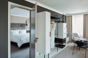 a bedroom with a bed and a mirror at London Marriott Maida Vale in London +53 photos
