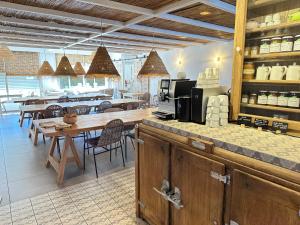 a restaurant with a counter and a table and chairs at Blanc Sable Hôtel in Golfe-Juan