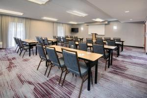 a conference room with tables and chairs and a whiteboard at Courtyard by Marriott Savannah Midtown in Savannah