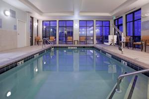 a swimming pool with a view of a building at Courtyard Grand Junction in Grand Junction