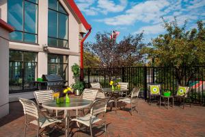 a patio with tables and chairs and a grill at Residence Inn by Marriott Toronto Airport in Toronto