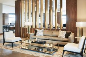 a living room with a couch and a coffee table at AC Hotel by Marriott Portland Downtown/Waterfront, ME in Portland