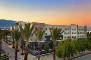 a large building with palm trees in front of it at Element Ontario Rancho Cucamonga in Ontario