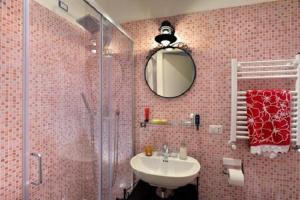 a bathroom with a sink and a shower with a mirror at Beside the Vatican in Rome