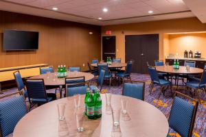 a conference room with tables and chairs and soda bottles at Courtyard by Marriott Bismarck North in Bismarck