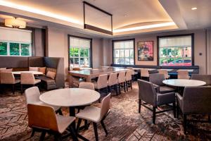 a restaurant with tables and chairs and windows at Residence Inn Alexandria Old Town/Duke Street in Alexandria