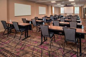 a conference room with tables and chairs and a whiteboard at Residence Inn Alexandria Old Town/Duke Street in Alexandria