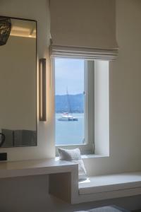 a bathroom with a window with a view of the water at Zaira Hotel in Skála Loutrón