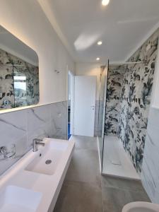 a bathroom with a sink and a shower at Casamediterranea in Sperlonga