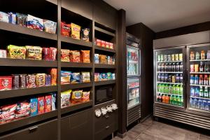 a store aisle with a refrigerator and lots of food at Courtyard by Marriott St Paul Woodbury in Woodbury