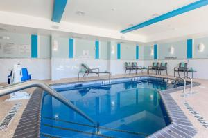 a pool in a hotel with chairs around it at Fairfield Inn & Suites by Marriott Wichita Falls Northwest in Wichita Falls