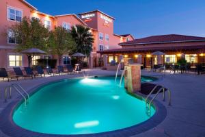 a swimming pool in the middle of a courtyard at Residence Inn Tucson Airport in Tucson