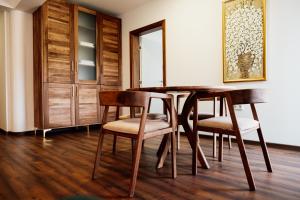 a dining room with a wooden table and chairs at Edemus - Motel & Restaurant in Maglaj