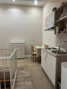 a kitchen with a sink and a table at La petite maison in Naples