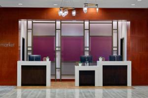 a lobby with purple walls and desks with chairs at Courtyard Portland Downtown / Convention Center in Portland
