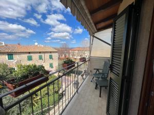 a balcony with a view of a building at Le Camere dei Magi in Saturnia