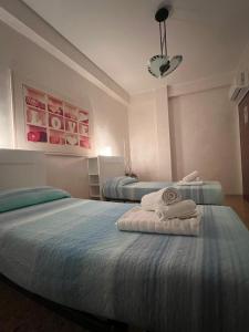 a bedroom with two beds with towels on them at Scicocco Sweet Home in Bagnoli del Trigno