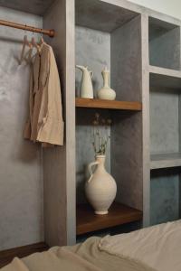a bedroom with a shelf with a vase on it at Casa Uva - Boutique Stay in Vejer de la Frontera +139 photos