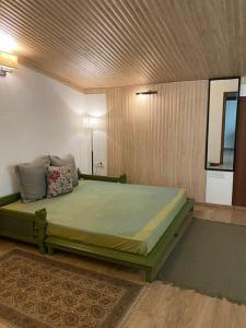a bedroom with a large bed in a room at Rustic Retreat by Roamhome - Modern 2BHK Apartment near Naini Lake in Nainital