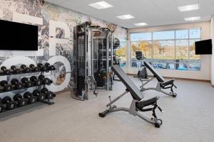 a gym with two exercise bikes and a flat screen tv at SpringHill Suites by Marriott St. George Washington in Washington