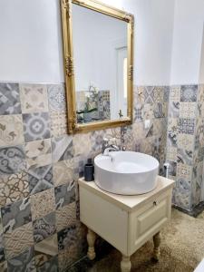 a bathroom with a sink and a mirror at Cozy apartment near city center in Bucharest