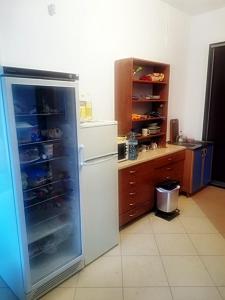 a kitchen with a refrigerator with its door open at Kwatery Mińsk Mazowiecki in Mińsk Mazowiecki