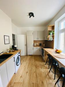 a kitchen with white cabinets and a table and chairs at Apartment Traumblick Berggipfel in Vordernberg