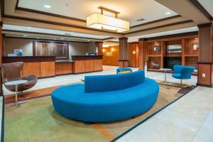 a large lobby with a blue couch and chairs at Fairfield Inn & Suites by Marriott San Antonio North/Stone Oak in San Antonio