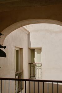 an archway in a building with two windows at Casa Uva - Boutique Stay in Vejer de la Frontera