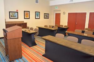 a conference room with tables and chairs and a podium at Fairfield Inn & Suites by Marriott Grand Junction Downtown/Historic Main Street in Grand Junction