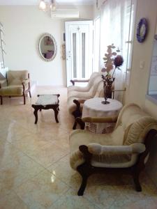 a living room with couches and a table in a room at Evis Maisonette with sea view in Flogita