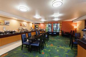 a restaurant with a table and chairs and a bar at Fairfield Mission Viejo Orange County in Mission Viejo