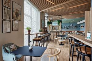 a restaurant with tables and chairs and a bar at Residence Inn by Marriott Strasbourg in Strasbourg