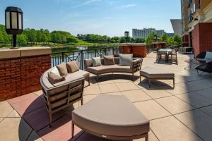a patio with couches and tables on a building at Courtyard by Marriott Gaithersburg Washingtonian Center in Gaithersburg