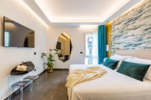 a bedroom with a bed and a large painting on the wall at Dei Martiri Suite in Naples