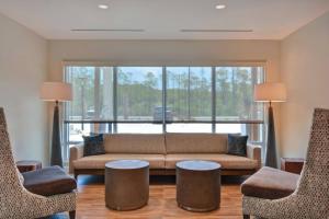 a living room with a couch and two chairs at TownePlace Suites by Marriott Panama City Beach Pier Park in Panama City Beach