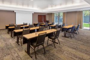 a conference room with tables and chairs and a screen at Courtyard by Marriott Reno in Reno