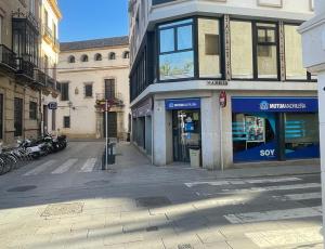 an empty street in a city with a building at BOHEMIAN & SUITES PANORAMIC -parking in Seville