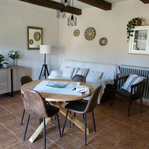 a dining room with a table and chairs and a couch at CAN PLANAS in Fonolleras