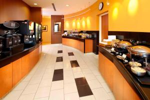 a large kitchen with a buffet line in a restaurant at Fairfield Inn & Suites Pittsburgh Neville Island in Robinson Township