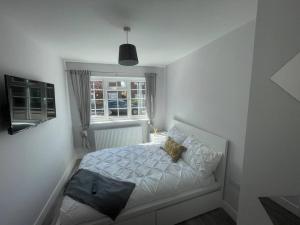 a dog sitting on a bed in a bedroom at DaisyChain Getaways at Chaney Rd in Wivenhoe