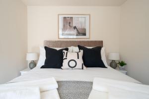 a bedroom with a bed with black and white pillows at Seaside Home in Stonehaven, Aberdeenshire in Stonehaven