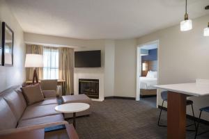a hotel room with a couch and a fireplace at Residence Inn Columbia MD in Ellicott City