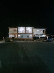 a large white building with lights on it at night at O FOGAR DAS FINAS in Melias