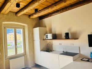A kitchen or kitchenette at Albola Suite Holiday Apartments