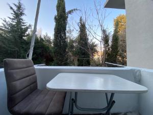 a white table and a chair on a balcony at MBAS Apartments in Istanbul