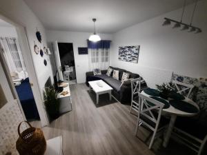 a living room with a couch and a table at Apartamentos Albaula 5 in El Cotillo